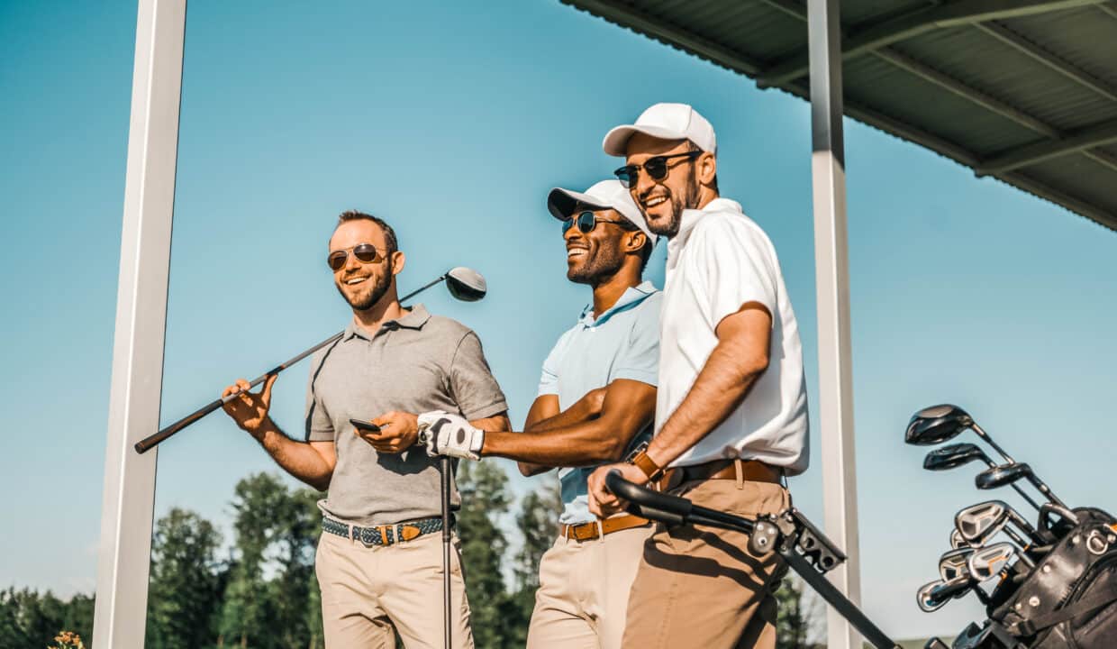 Three,Smiling,Men,In,Sunglasses,Holding,Golf,Clubs,Outdoors